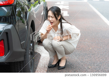 Woman checking a car 130956899