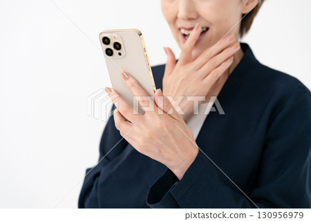 A woman surprised at her smartphone A woman surprised at her smartphone 130956979