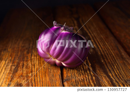 Eggplant on wooden background, fresh juicy vegetable on wooden rustic background, selective focus, soft focus Eggplant on wooden background, fresh juicy vegetable on wooden rustic background, selective focus, soft focus 130957727