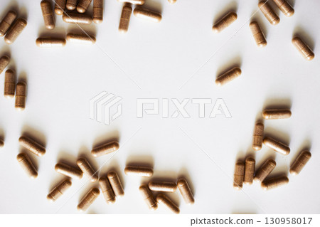 Herbal medicine capsules spread on white background for nutrition and healthcare 130958017