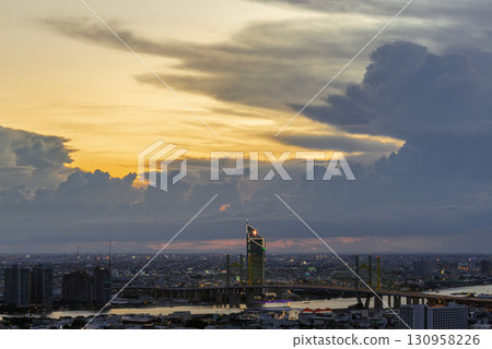 Beautiful skyscrapers view and the Bridge crosses the Chao Phraya river of Bangkok city with Dramatic sky background at before sunset. Beautiful skyscrapers view and the Bridge crosses the Chao Phraya river of Bangkok city with Dramatic sky background at before sunset. 130958226