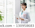 Young female doctor working in hospital 130958683