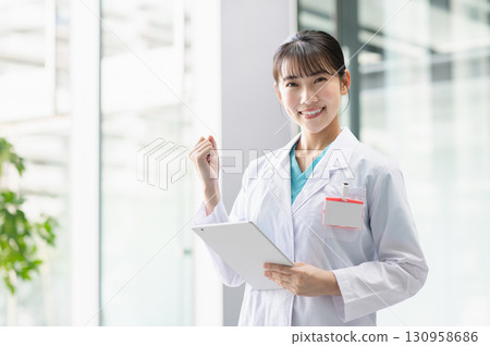 Young female doctor working in hospital Young female doctor working in hospital 130958686