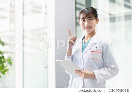 Young female doctor working in hospital 130958688