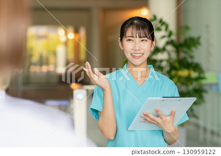 A young female doctor examining a patient 130959122