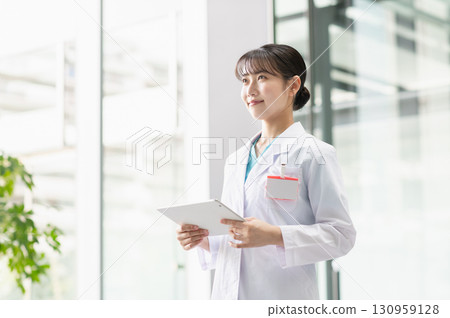 Young female doctor working in hospital 130959128