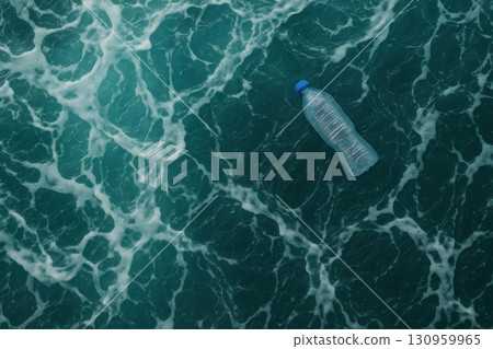 Floating plastic bottle on ocean surface highlights pollution issue during sunny daylight 130959965