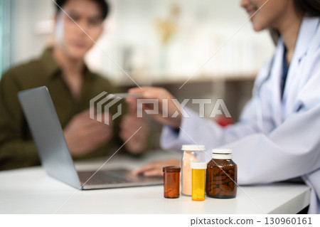 Medication Review. Dietitian discussing treatment options with a male patient. Medication Review. Dietitian discussing treatment options with a male patient. 130960161