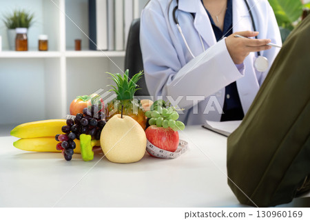 Nutrition Counseling. Doctor discussing healthy food options with patient. Nutrition Counseling. Doctor discussing healthy food options with patient. 130960169