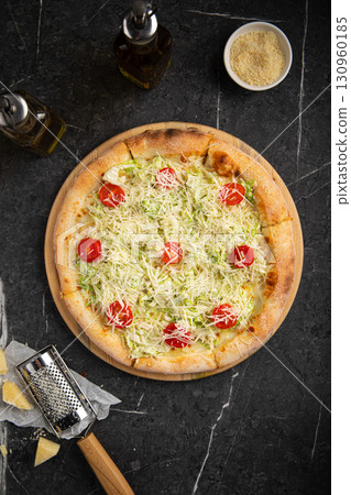 Caesar pizza with cherry tomatoes and lettuce Caesar pizza with cherry tomatoes and lettuce 130960185