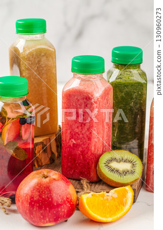 Smoothie in plastic bottle with kiwi and orange 130960273