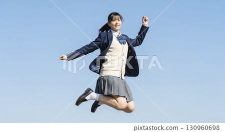 High school girl jumping under the blue sky 130960698