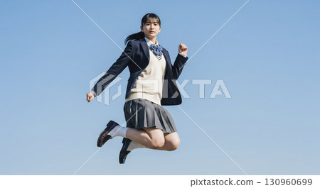 High school girl jumping under the blue sky 130960699