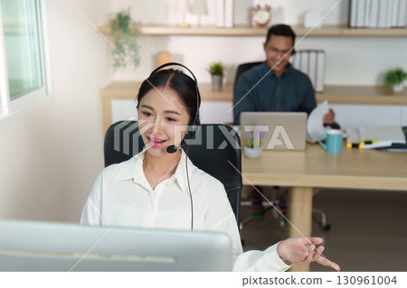 Engaged Call Center Agent Assisting Clients in Modern Office Engaged Call Center Agent Assisting Clients in Modern Office 130961004