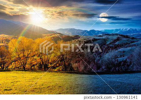 mountain landscape on autumn equinox. day and night time change concept. beautiful view with trees in colorful foliage. picturesque rural place in alps with sun and moon at twilight. countryside mountain landscape on autumn equinox. day and night time change concept. beautiful view with trees in colorful foliage. picturesque rural place in alps with sun and moon at twilight. countryside 130961141