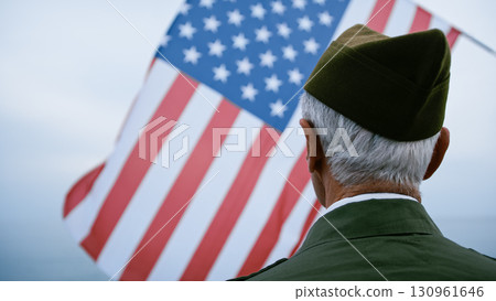 Old Veteran Soldier Looking Up At The USA Flag 130961646