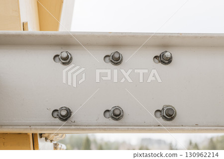 Structural steel beam close up with bolted connection and hex nuts on site Structural steel beam close up with bolted connection and hex nuts on site 130962214