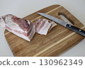 Ukrainian traditional cuisine. Very tasty pieces of salo. Raw ukrainian bacon or salo on wooden board. Sliced salted pork lard (salo). Food concept. 130962349