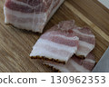 Ukrainian traditional cuisine. Very tasty pieces of salo. Raw ukrainian bacon or salo on wooden board. Sliced salted pork lard (salo). Food concept. 130962353