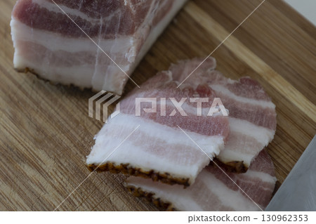 Ukrainian traditional cuisine. Very tasty pieces of salo. Raw ukrainian bacon or salo on wooden board. Sliced salted pork lard (salo). Food concept. Ukrainian traditional cuisine. Very tasty pieces of salo. Raw ukrainian bacon or salo on wooden board. Sliced salted pork lard (salo). Food concept. 130962353