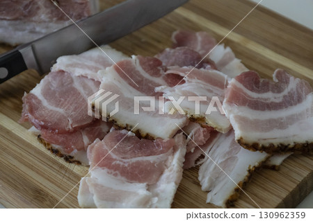 Ukrainian traditional cuisine. Very tasty pieces of salo. Raw ukrainian bacon or salo on wooden board. Sliced salted pork lard (salo). Food concept. Ukrainian traditional cuisine. Very tasty pieces of salo. Raw ukrainian bacon or salo on wooden board. Sliced salted pork lard (salo). Food concept. 130962359