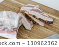 Ukrainian traditional cuisine. Very tasty pieces of salo. Raw ukrainian bacon or salo on wooden board. Sliced salted pork lard (salo). Food concept. 130962362