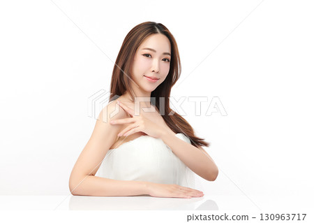 A beautiful young Asian woman with clean, fresh skin against a white background. Skincare, facial treatment, cosmetology, beauty, and spa. An elegant portrait of an Asian woman. 130963717