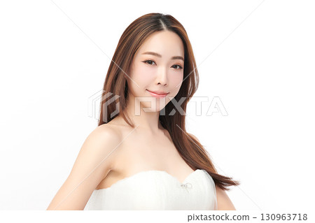 A beautiful young Asian woman with clean, fresh skin against a white background. Skincare, facial treatment, cosmetology, beauty, and spa. An elegant portrait of an Asian woman. 130963718