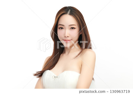 A beautiful young Asian woman with clean, fresh skin against a white background. Skincare, facial treatment, cosmetology, beauty, and spa. An elegant portrait of an Asian woman. 130963719