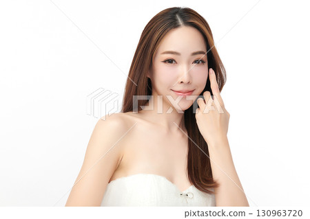 A beautiful young Asian woman with clean, fresh skin against a white background. Skincare, facial treatment, cosmetology, beauty, and spa. An elegant portrait of an Asian woman. 130963720