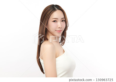 A beautiful young Asian woman with clean, fresh skin against a white background. Skincare, facial treatment, cosmetology, beauty, and spa. An elegant portrait of an Asian woman. 130963725
