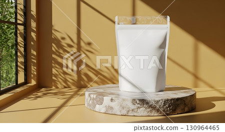 Minimalist white stand-up pouch on a marble surface in natural sunlight with green foliage shadows Minimalist white stand-up pouch on a marble surface in natural sunlight with green foliage shadows 130964465