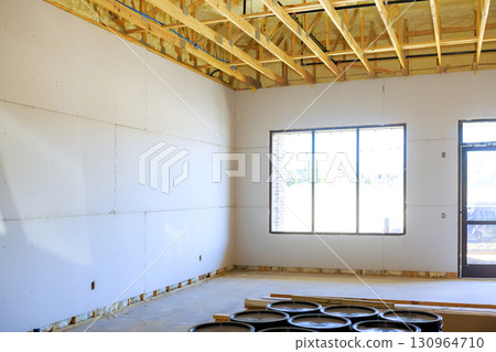 Newly constructed interior space with exposed beams large windows in modern building 130964710