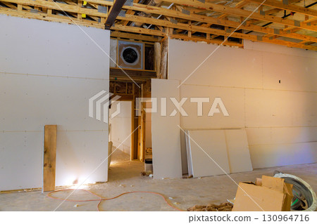Construction progress in residential building showing framed wall drywall installation Construction progress in residential building showing framed wall drywall installation 130964716