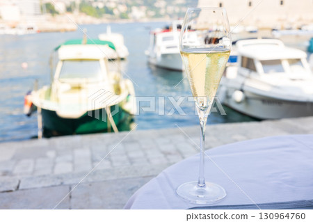 Delicious sparkling wine at a European bayside restaurant 130964760