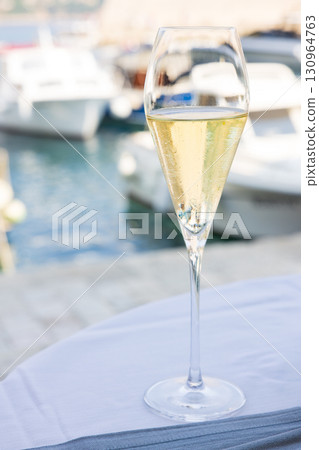 Delicious sparkling wine at a European bayside restaurant 130964763