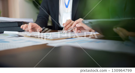 Collaborative financial analysis with professionals reviewing charts and data 130964799