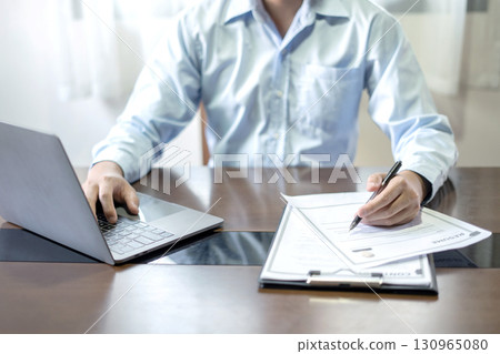 Business man employer holding resume hiring recruit looking cv resume to hire candidates, analyzing information before job interview. Recruitment concepts Business man employer holding resume hiring recruit looking cv resume to hire candidates, analyzing information before job interview. Recruitment concepts 130965080