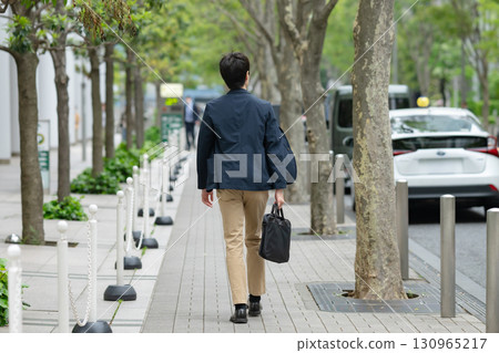 Businessman walking in the office town Businessman walking in the office town 130965217