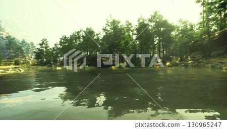 A calm lake reflects the vibrant greenery of surrounding pine trees under bright daylight. The tranquil water enhances the peaceful atmosphere of this natural setting. A calm lake reflects the vibrant greenery of surrounding pine trees under bright daylight. The tranquil water enhances the peaceful atmosphere of this natural setting. 130965247