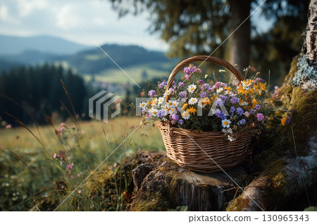 Wicker Basket of Wildflowers in a Mountain Meadow 130965343