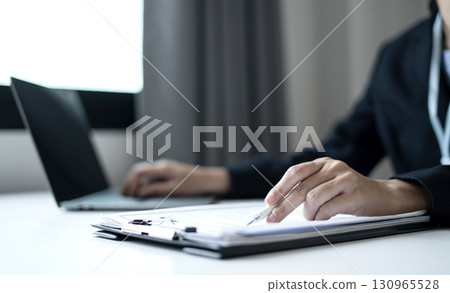 Business woman employer holding resume hiring recruit looking cv resume to hire candidates, analyzing information before job interview. Recruitment concepts Business woman employer holding resume hiring recruit looking cv resume to hire candidates, analyzing information before job interview. Recruitment concepts 130965528