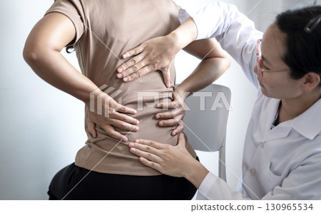 Female patients consulted physiotherapists with Low back pain for examination and treatment. Rehabilitation physiotherapy concept 130965534