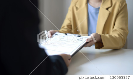 Business people hold a resume and talk to job applicants for job interviews about careers and Their personal history in the company. Recruitment concepts Business people hold a resume and talk to job applicants for job interviews about careers and Their personal history in the company. Recruitment concepts 130965537