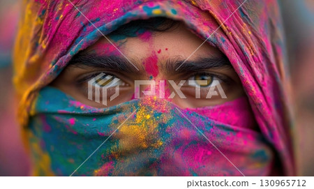 Portrait with vibrant colors on fabric and skin in bright closeup, Holi celebration in Indian city 130965712