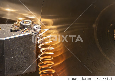 Close up scene the lathe machine finish cut the brass material parts by chip insert tool. 130966191