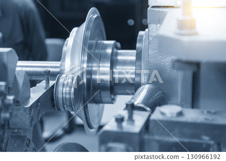 Close up scene the metal spinning process by lathe machine in the light blue scene. 130966192