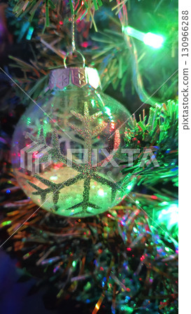 Christmas tree decorated with beautiful transparent ball with abstract snowflake 130966288