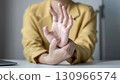 Woman hand with wrist pain numbness and pain in the palm of the hand has pain and tingling in the nerve endings This is a side effect of sitting and working for a long time on a laptop at the office 130966574
