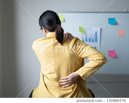 Woman having back and shoulder pain pain during work long time. stretching to relax and relax while working hard at the office Woman having back and shoulder pain pain during work long time. stretching to relax and relax while working hard at the office 130966576